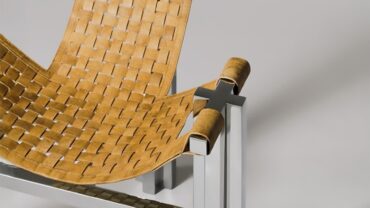 Woven mycelium seat with sleek silver metal frame, showcasing a modern design; warm tones contrast with minimalistic base.