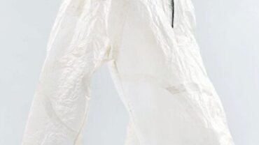 White, lightweight jacket displayed against a minimalist background, featuring a zippered front and adjustable cords at the hem and sleeves.